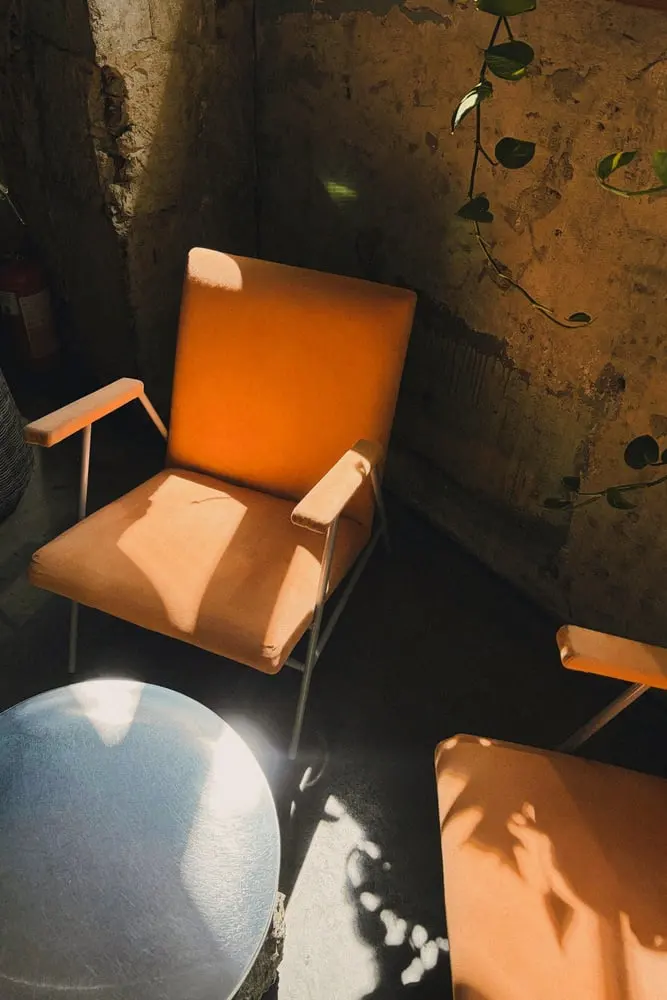orange armchairs in sunlit room