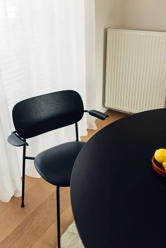 a black table with a bowl of fruit on it
