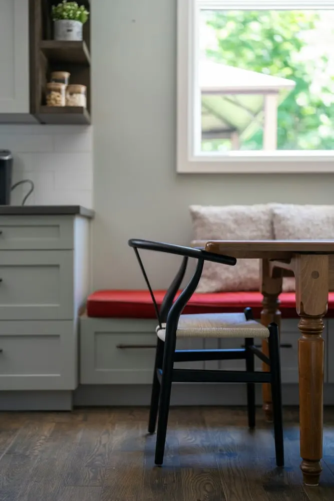 black wishbone chair in a modern kitchen dining nook