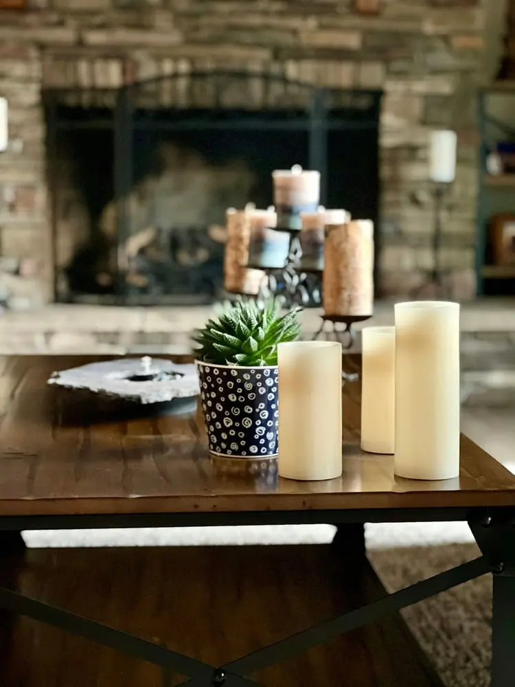 a table with candles and a plant
