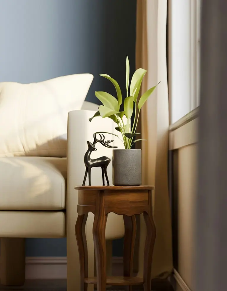 plant and deer figurine on table