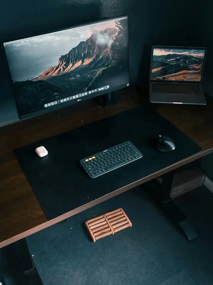 a desk with a keyboard mouse and monitor on it