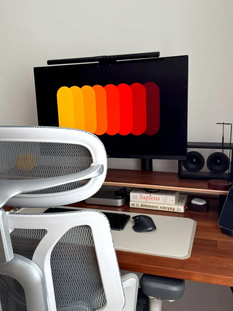 desk setup with computer monitor and chairs