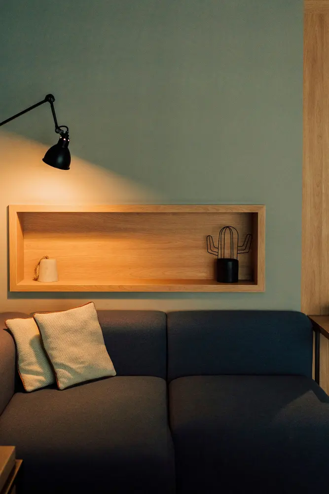 a living room with a couch and a lamp