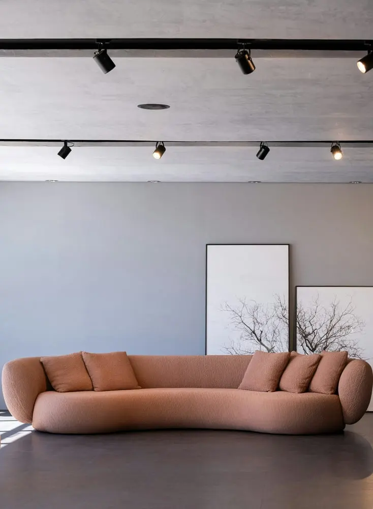 a modern peach sofa with pillows in a room