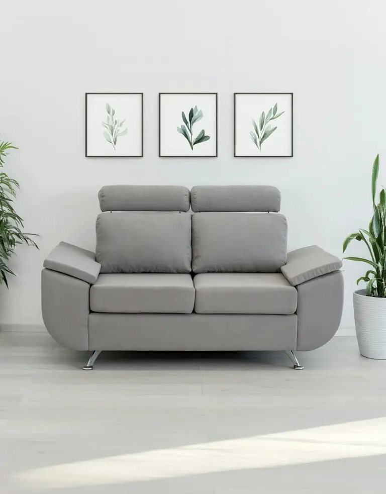 a modern gray loveseat with plants and art