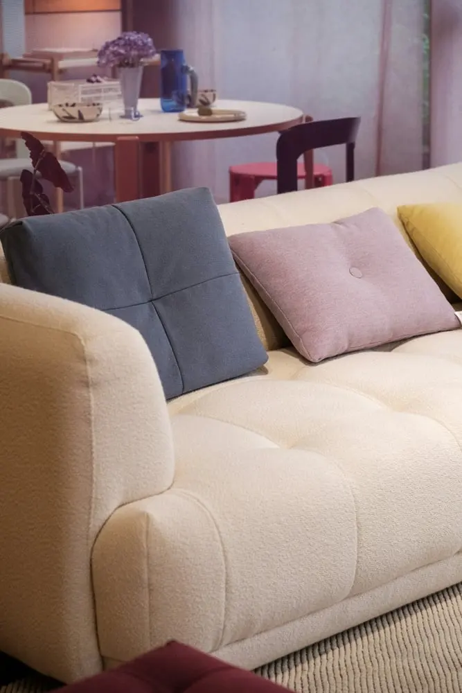 cream tufted sofa with colorful cushions