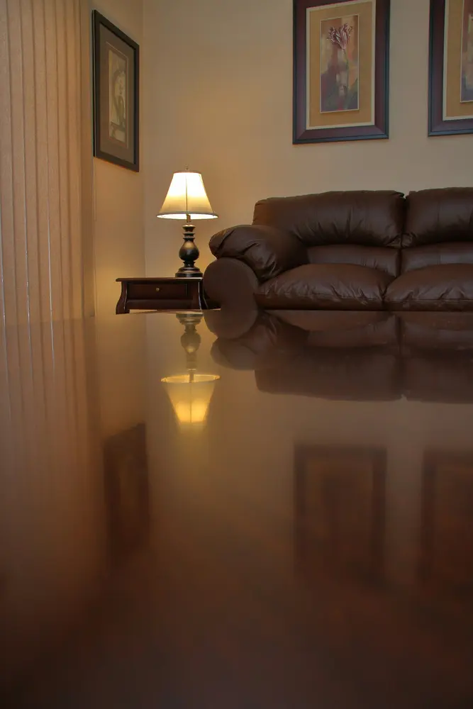 warm living room with leather couch and reflective floor