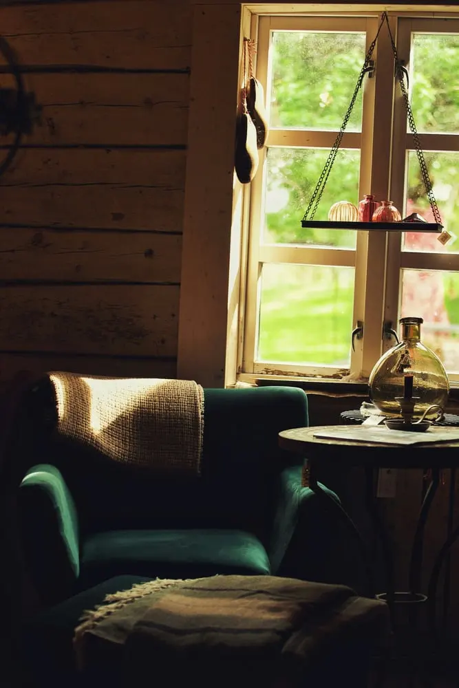 a room with a chair table and a window