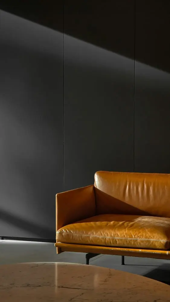 modern tan leather sofa in a minimalist room