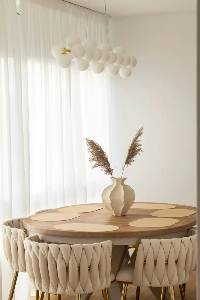 dining table with chairs and dried flowers