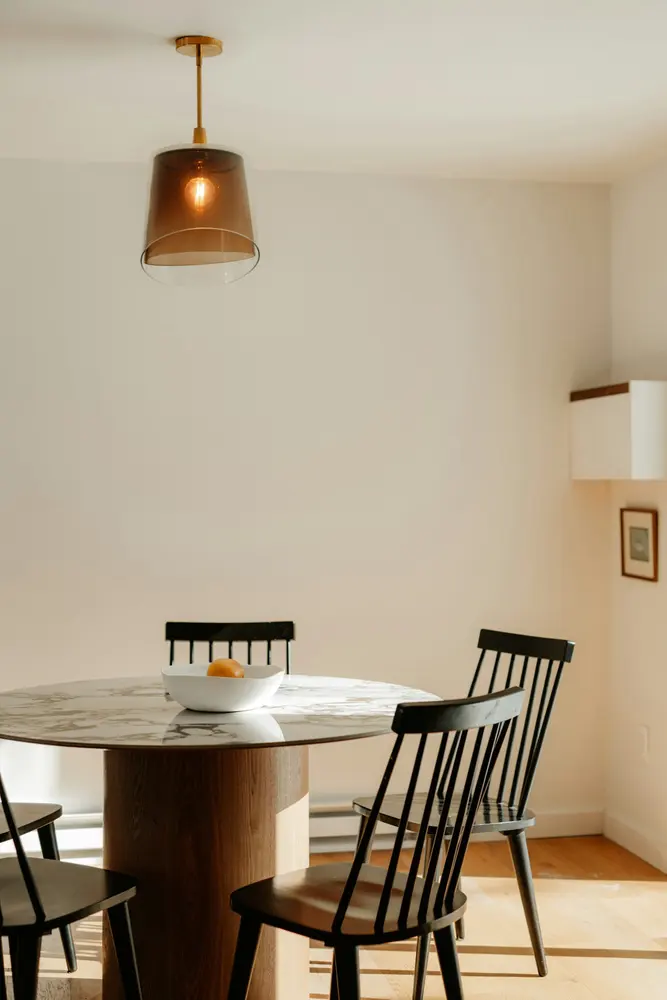 modern dining table with chairs in sunlit room