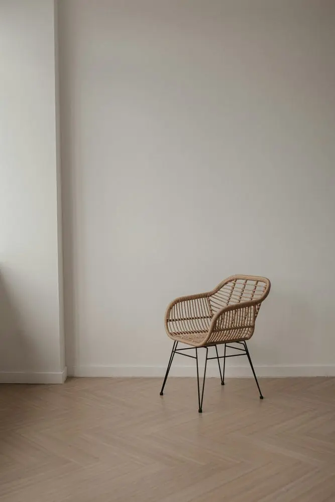wicker chair with metal legs on a wooden floor