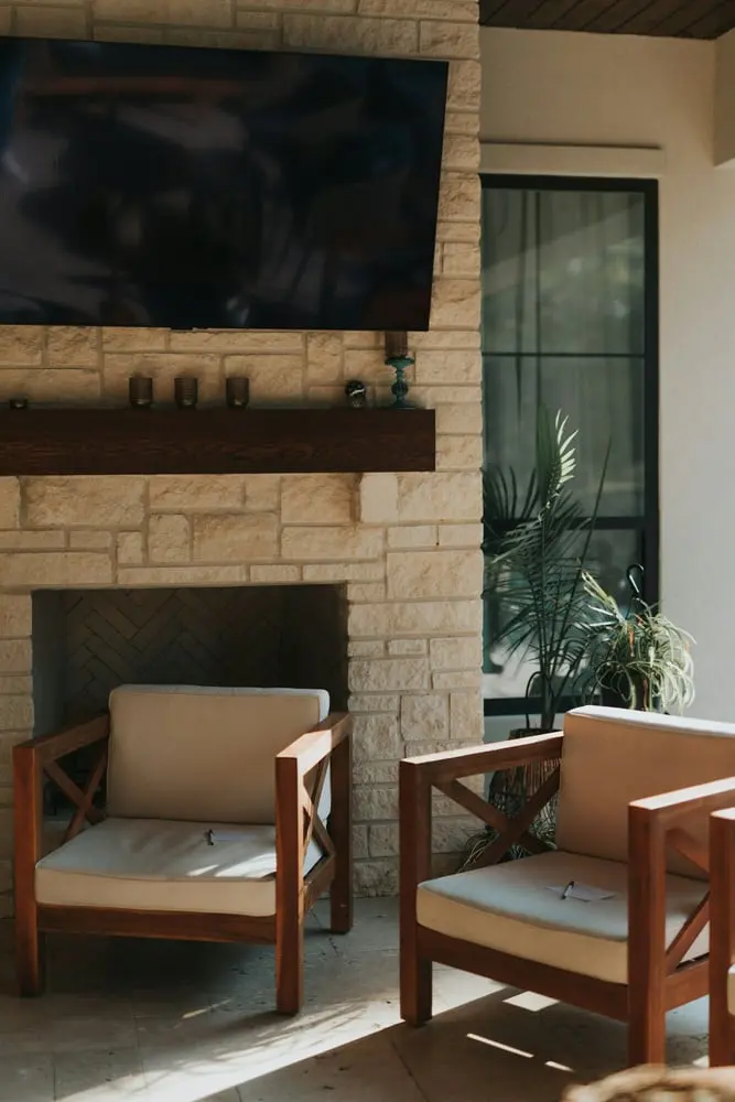a fireplace with chairs in front of it