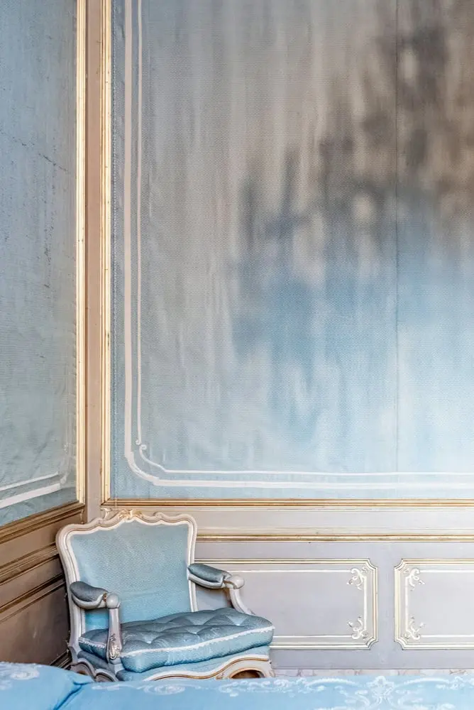 a bedroom with a bed and a chair in it